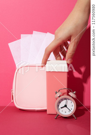 Wax strips for depilation with a pink cosmetic bag 117560980