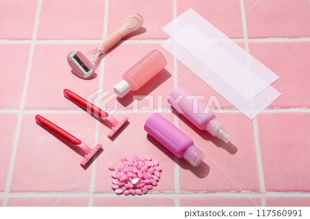 Accessories for depilation on a pink background Accessories for depilation on a pink background 117560991