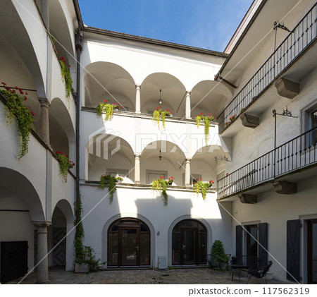 flowers on the balcony inside a typical courtyard between old buildings in Linz, Austruia 117562319