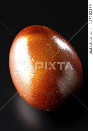 Smoked eggs photographed against a black background Smoked eggs photographed against a black background 117562379