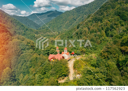Aerial view of a serene mountain male monastery in a lush forest, evoking tranquility and calmness 117562923