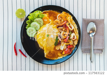Spicy Tom Yum Kung Omelette, a popular Thai dish with nutritious fusion food. 117563122