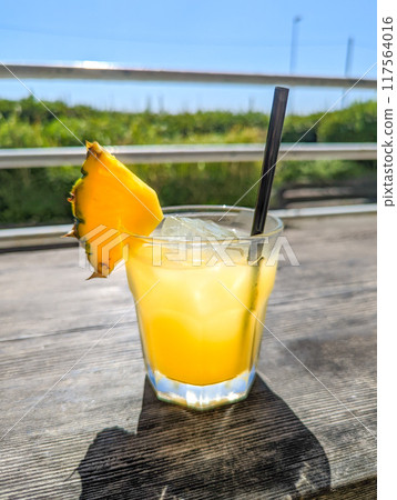 Pineapple juice on a midsummer terrace 117564016
