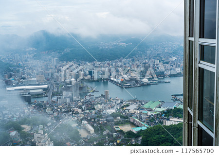 Nagasaki cityscape shrouded in mist and clouds from the Inasayama Observatory [Nagasaki City] 117565700