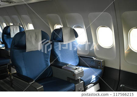 Airplane interior. Empty passenger seats in an airplane cabin 117566215