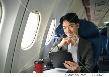 Successful businessman in elegant suit working with digital in aircraft during business travel Successful businessman in elegant suit working with digital in aircraft during business travel 117566219
