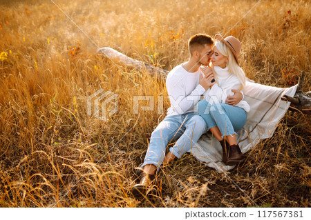 Young couple having fun walking and hugging n the park. Autumn weather. Relaxation, youth. Young couple having fun walking and hugging n the park. Autumn weather. Relaxation, youth. 117567381
