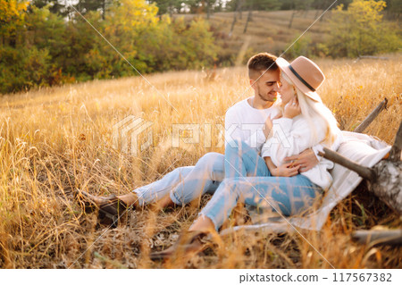 Young couple having fun walking and hugging n the park. Autumn weather. Relaxation, youth. Young couple having fun walking and hugging n the park. Autumn weather. Relaxation, youth. 117567382