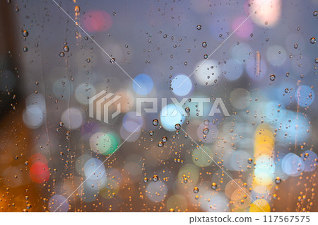 Water droplets on a window at night and street lights 117567575