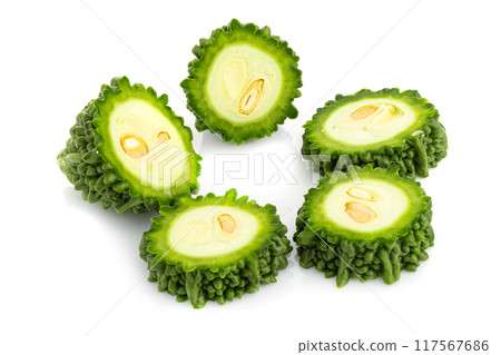 Fresh bitter gourd Bitter cucumber or bitter melon with cut slice isolated on a white background. Fresh bitter gourd Bitter cucumber or bitter melon with cut slice isolated on a white background. 117567686