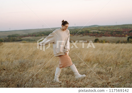 Beautiful woman walk in the field sunny day Beautiful woman walk in the field sunny day 117569142
