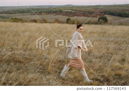 Beautiful woman walk in the field sunny day 117569143