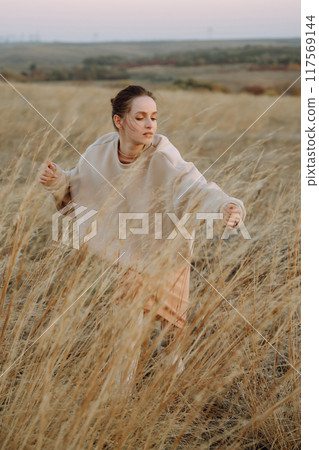 Beautiful woman walk in the field sunny day Beautiful woman walk in the field sunny day 117569144