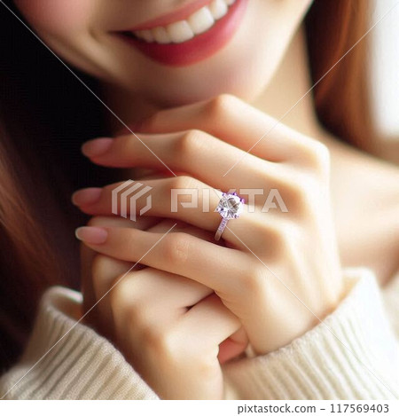 A woman smiling at the ring on her left ring finger 117569403