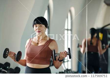 Woman Training With Dumbbells In Sport Gym Woman Training With Dumbbells In Sport Gym 117569751