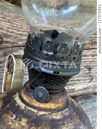 An old kerosene lamp with a glass shade. Close up. An old kerosene lamp with a glass shade. Close up. 117570451