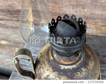 An old kerosene lamp. The glass shade is next to it. A close-up of the wick. An old kerosene lamp. The glass shade is next to it. A close-up of the wick. 117570456