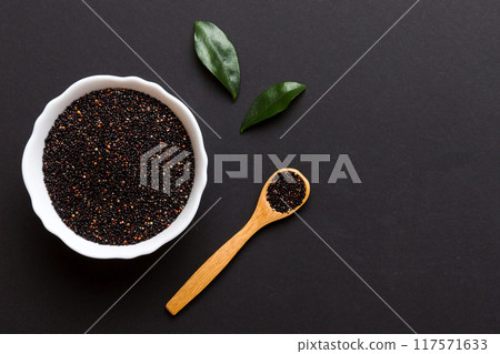 quinoa seeds in bowl and spoon on colored background. Healthy kinwa in small bowl. Healthy superfood 117571633