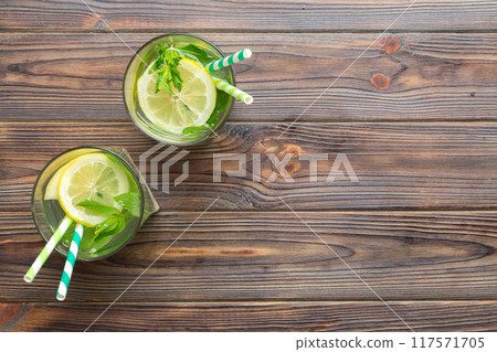 Caipirinha, Mojito cocktail, vodka or soda drink with lime, mint and straw on table background. Refreshing beverage with mint and lime in glass top view flat lay 117571705