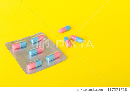 Medicine pills on a light background. Medicines and prescription pills flat lay background. Blue and pink medical tablets in blister Medicine pills on a light background. Medicines and prescription pills flat lay background. Blue and pink medical tablets in blister 117571718