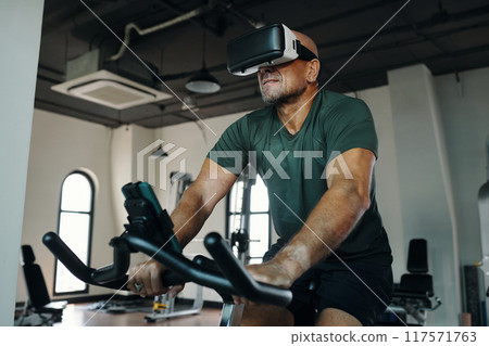 Man Exercising In VR Glasses In Gym 117571763