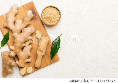 ginger on Cutting board table, top view. Space for text ginger on Cutting board table, top view. Space for text 117571857