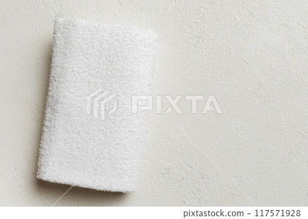 Top view of white towels with copy space on colored background Top view of white towels with copy space on colored background 117571928