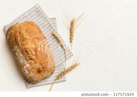 Fresh Homemade Whole Wheat Bread. bread on napkin on rustic background, fresh bread top view Fresh Homemade Whole Wheat Bread. bread on napkin on rustic background, fresh bread top view 117571929
