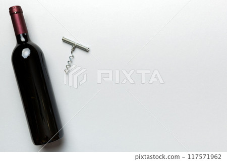 One Bottle of red wine with corkscrew on colored table. Flat lay, top view wth copy space One Bottle of red wine with corkscrew on colored table. Flat lay, top view wth copy space 117571962