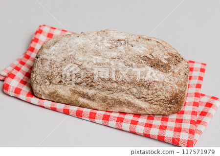 freshly baked bread with napkin on rustic table top view. Healthy white bread loaf isolated freshly baked bread with napkin on rustic table top view. Healthy white bread loaf isolated 117571979