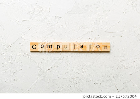 compulsion word written on wood block. compulsion text on table, concept compulsion word written on wood block. compulsion text on table, concept 117572004