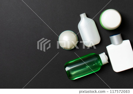 Cosmetics SPA branding mock-up, top view with copy space. set of tubes and jars of cream flat lay on colored background 117572083