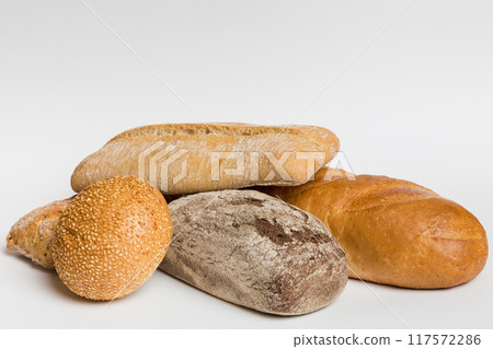Homemade natural breads. Different kinds of fresh bread as background, perspective view with copy space 117572286