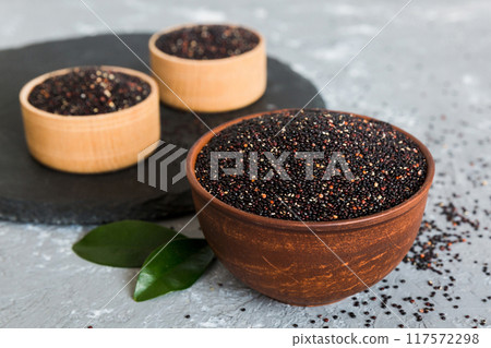 quinoa seeds in bowl on colored background. Healthy kinwa in small bowl. Healthy superfood 117572298