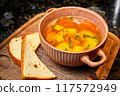 Soup with potatoes and white bread croutons 117572949