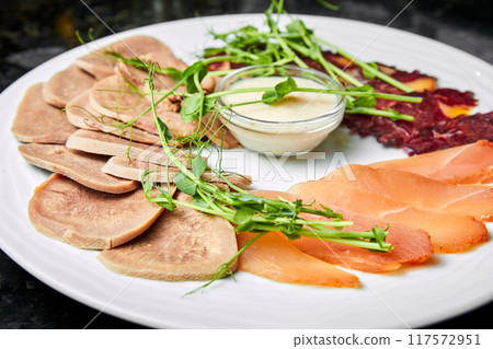 Assorted meats of makhan, chicken balyk and beef tongue with creamy sauce Assorted meats of makhan, chicken balyk and beef tongue with creamy sauce 117572951