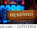 Sign with the inscription Reserved on the restaurant table 117572954