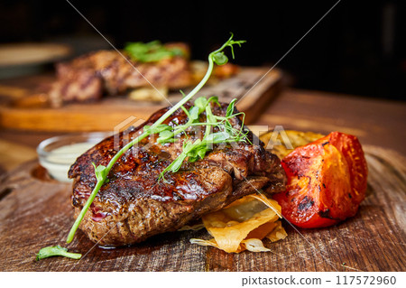 Veal with vegetable ratatouille and pepper sauce Veal with vegetable ratatouille and pepper sauce 117572960