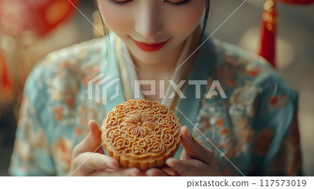A young woman wearing traditional Chinese clothing Hanfu, holding mooncakes. Mid-Autumn festival 117573019
