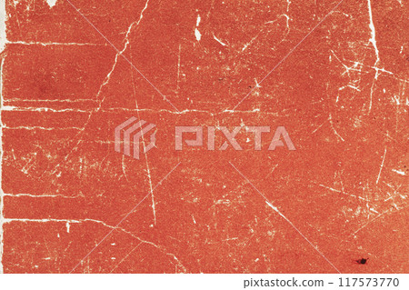 Aged, stained red paper, grungy, distressed red texture with white scratches and cracks 117573770