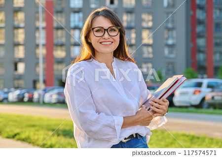 Outdoor portrait of middle aged businesswoman, modern urban city background Outdoor portrait of middle aged businesswoman, modern urban city background 117574571