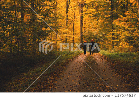 couple with pumpkin head in fall forest couple with pumpkin head in fall forest 117574637