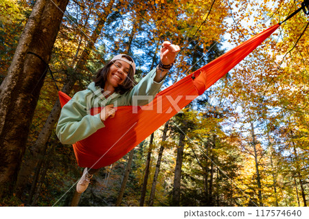 Relaxing in a Hammock in Autumn Forest Relaxing in a Hammock in Autumn Forest 117574640