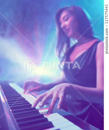 Festival of instrumental music. Photo with focus on elegant, flexible fingers of woman, performing piano solo. 117575441
