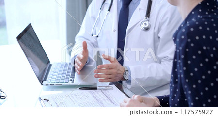 Doctor man and patient woman are talking in clinic after health exam. Medicine concept 117575927