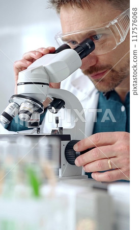 Man scientist with protective glasses using microscope in laboratory. Microbiology science concept Man scientist with protective glasses using microscope in laboratory. Microbiology science concept 117576068