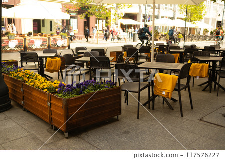 Cozy street with tables of cafe in Krakow, Poland. Architecture and landmark. Cozy cityscape 117576227