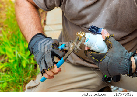 During process of connecting pvc plastic faucets to water supply system, plumber seals faucets together During process of connecting pvc plastic faucets to water supply system, plumber seals faucets together 117576833
