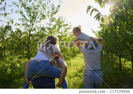 parents ride their children on their backs parents ride their children on their backs 117576999