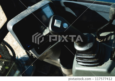 Controls of a small excavator in the cab. Background for special equipment theme concept Controls of a small excavator in the cab. Background for special equipment theme concept 117577412